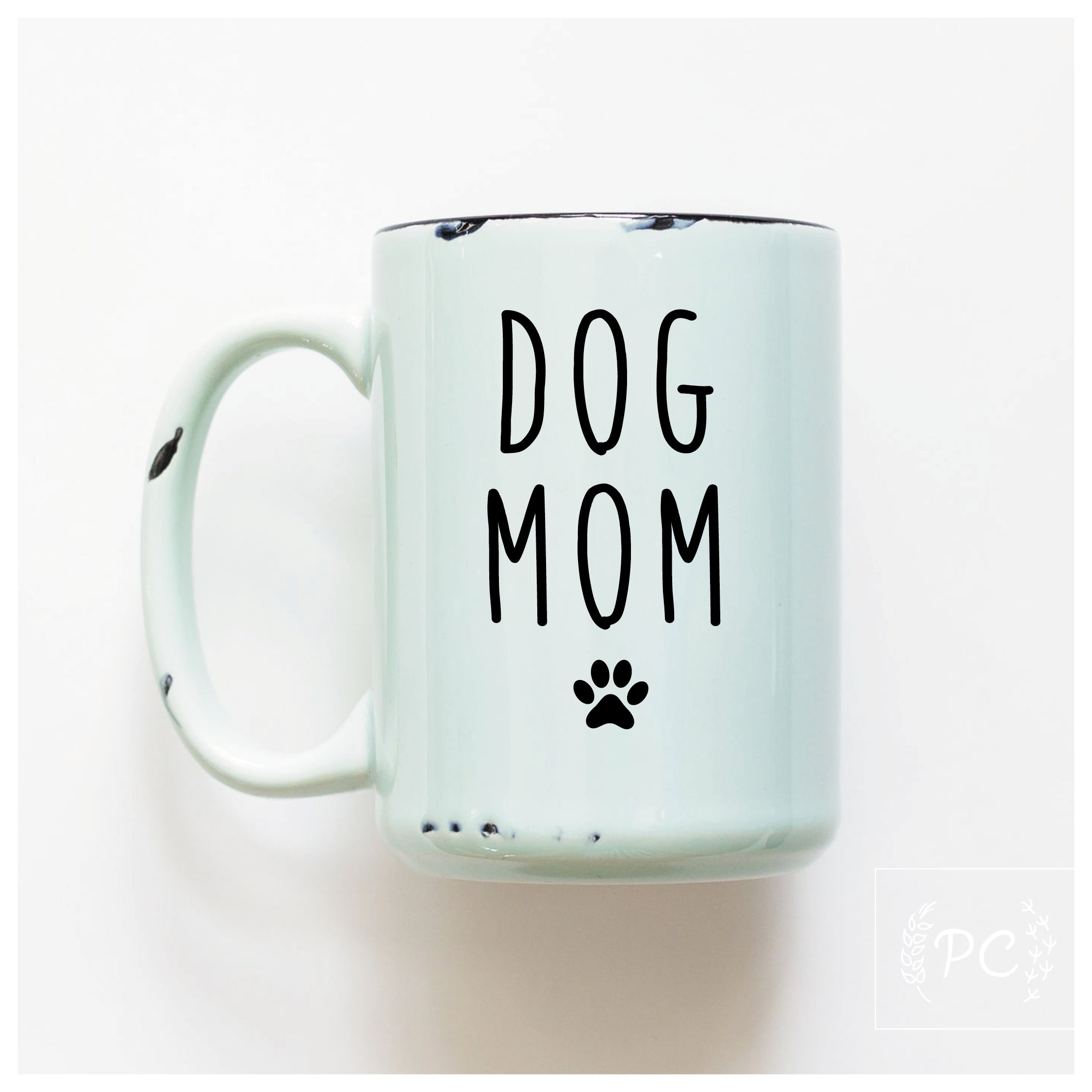Mint green mug with 'DOG MOM' text and paw print on a white background