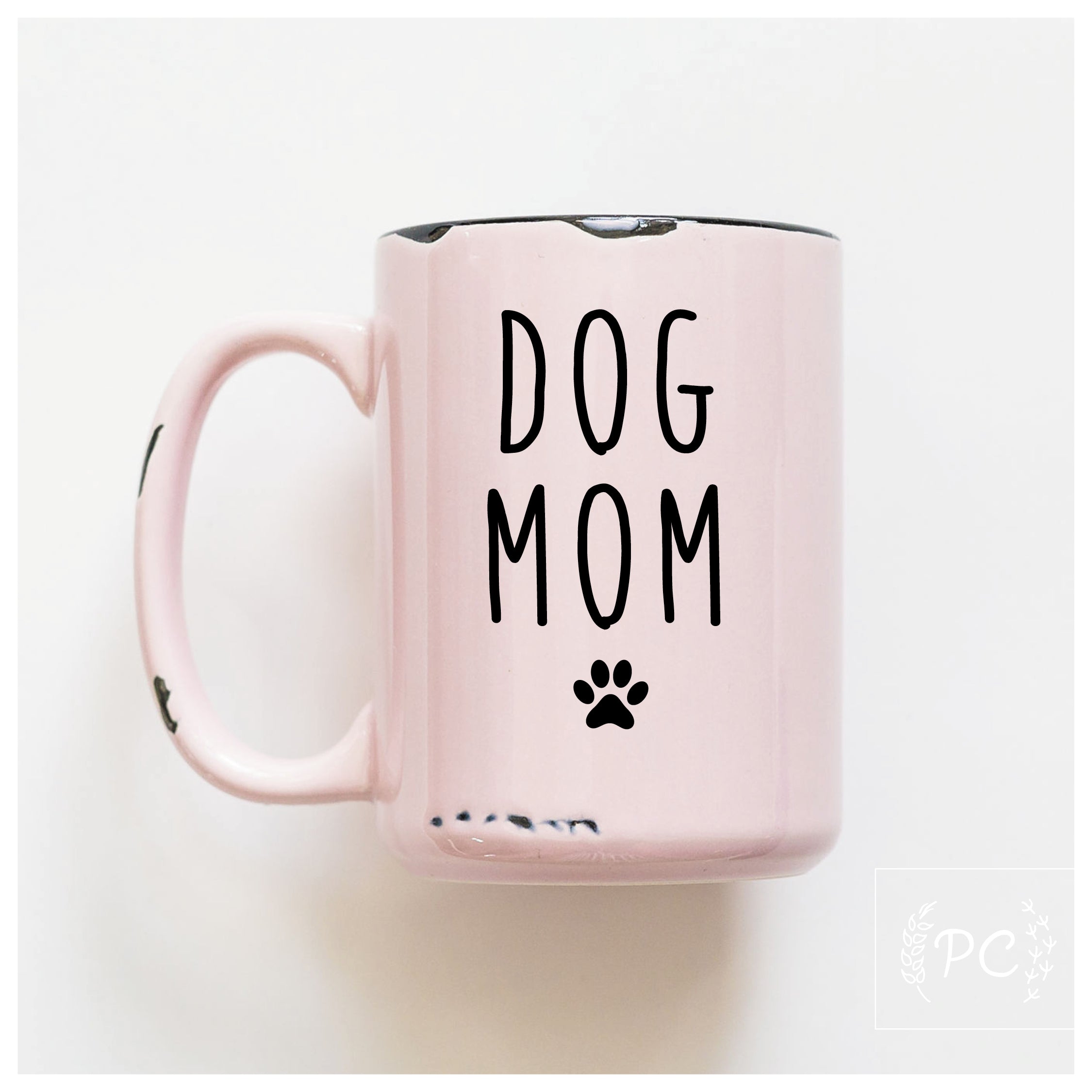 Pink mug with 'DOG MOM' text on a white background