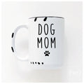 White mug with 'DOG MOM' text and paw prints on a white background