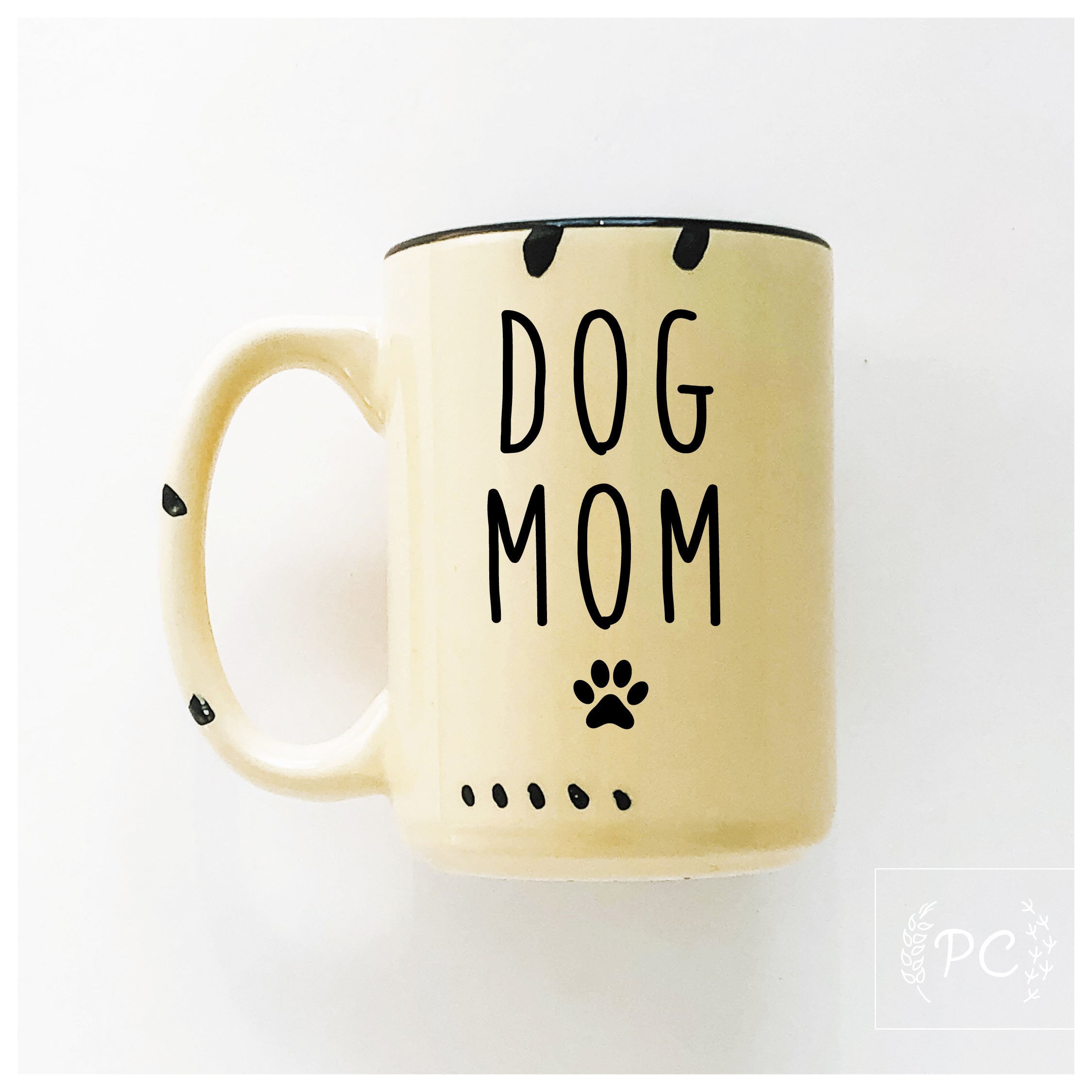 Yellow mug with 'DOG MOM' text and paw print on a white background