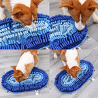 Dog interacting with a blue textured snuffle mat on a wooden floor.