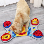 Dog playing with a snuffle mat on a wooden floor