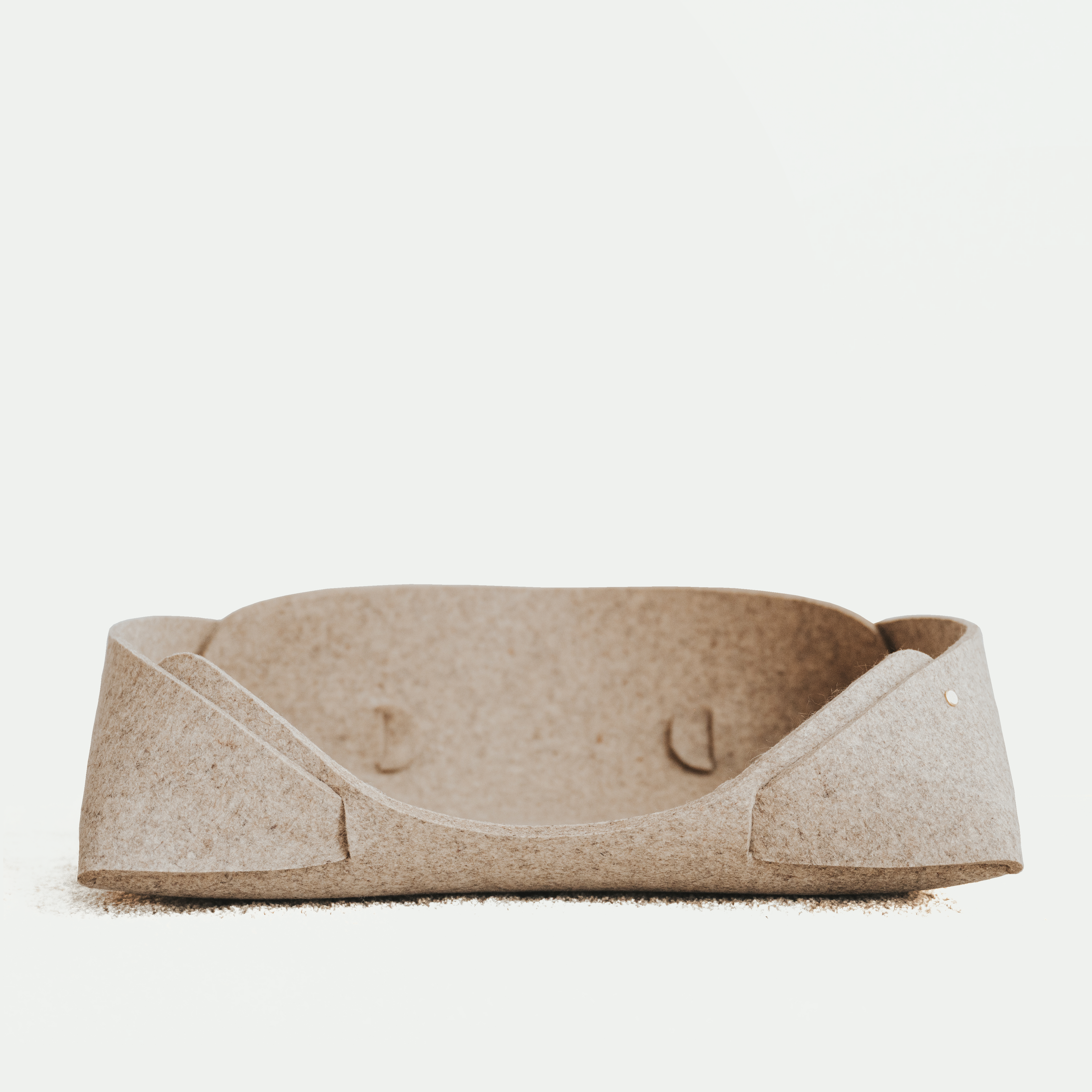 Beige pet bed on a white background