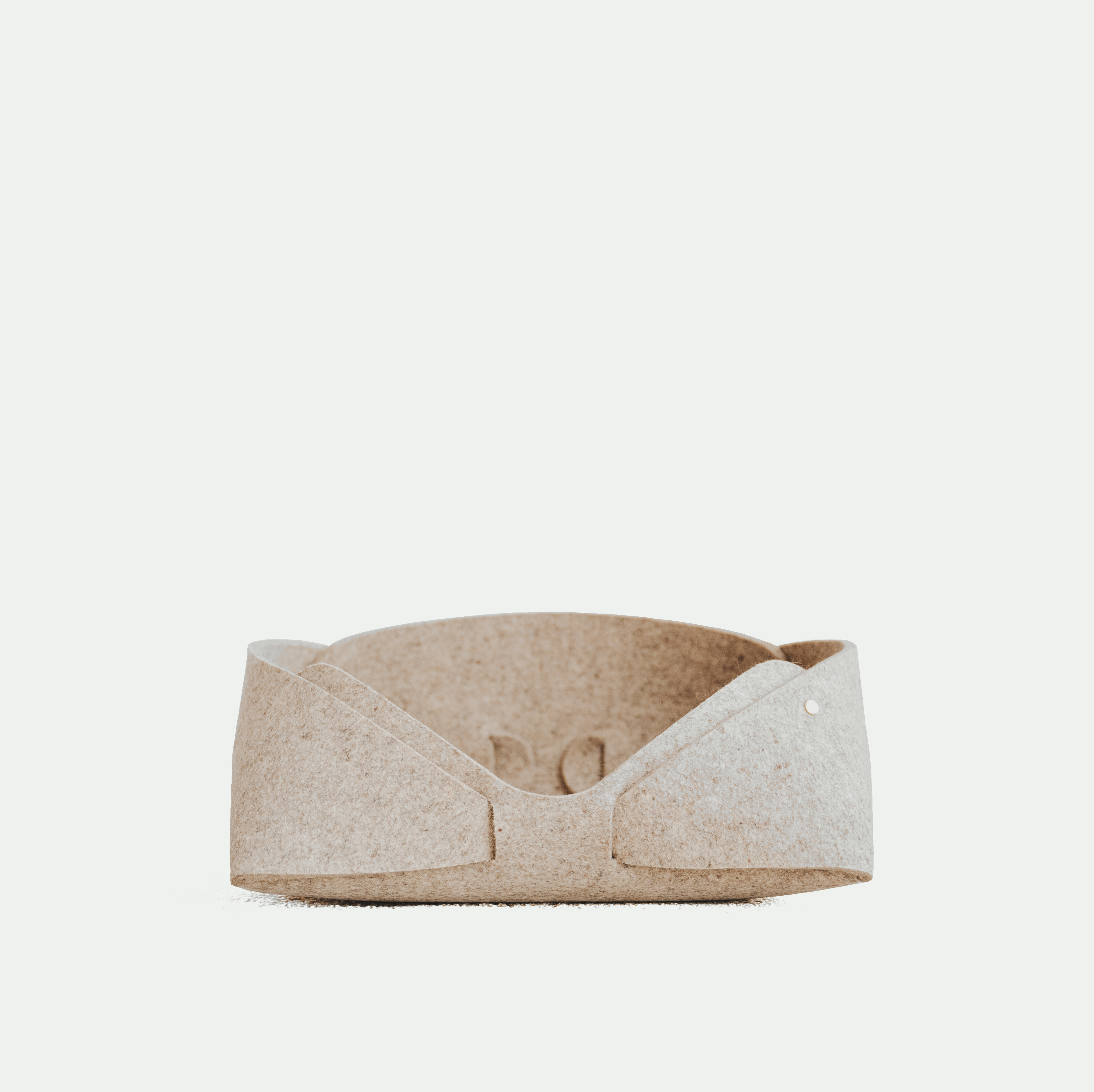 Beige pet bed on a white background