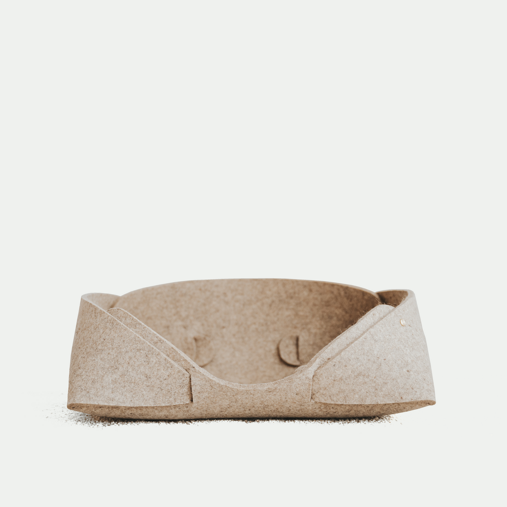 Beige pet bed on a white background