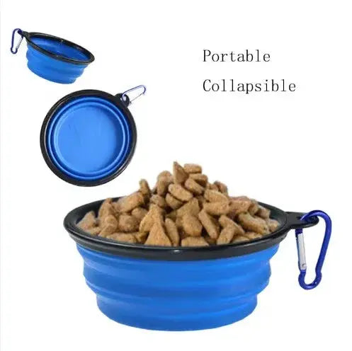 Collapsible blue pet bowl filled with dog food on a white background