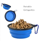 Collapsible blue pet bowl filled with dog food on a white background