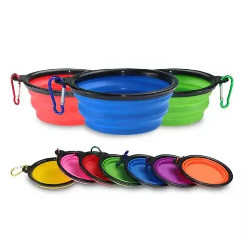 Set of colorful collapsible dog bowls with carabiners on a white background