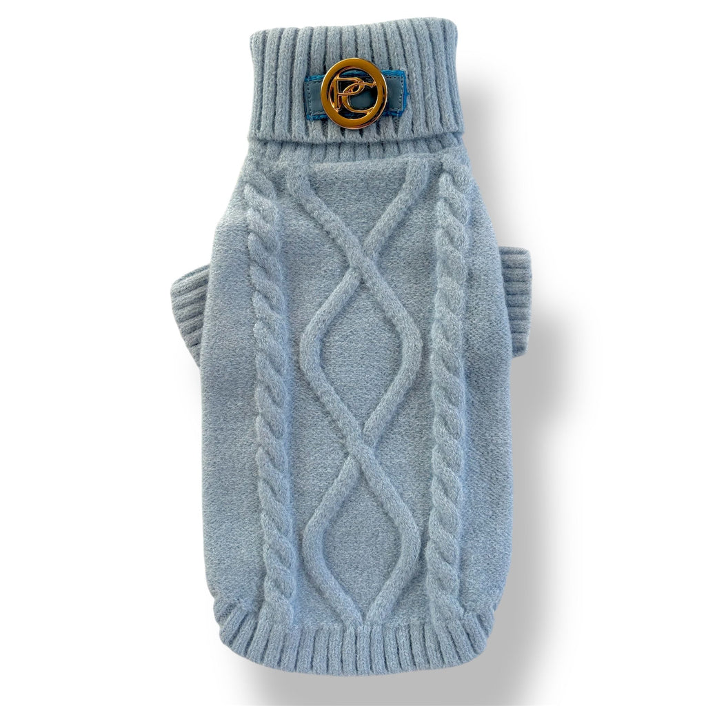 Blue knitted dog sweater with a decorative button on a white background