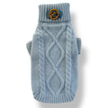 Blue knitted dog sweater with a decorative button on a white background