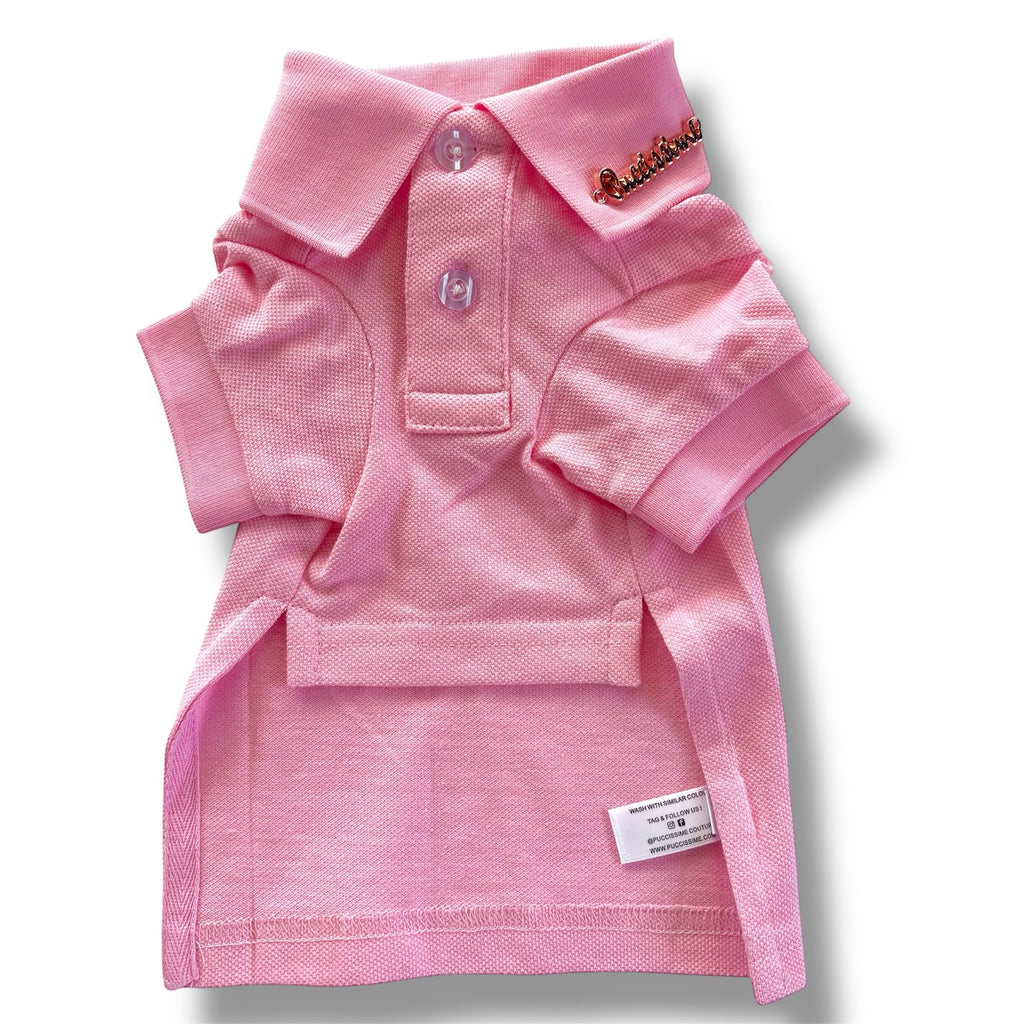 Pink dog polo shirt with a brand label on a white background