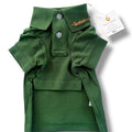 Green dog polo shirt with a brand tag on a white background