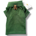 Green dog polo shirt with a teddy bear charm and a visible brand tag on a white background
