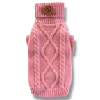 Pink knitted dog sweater with a brown button on a white background