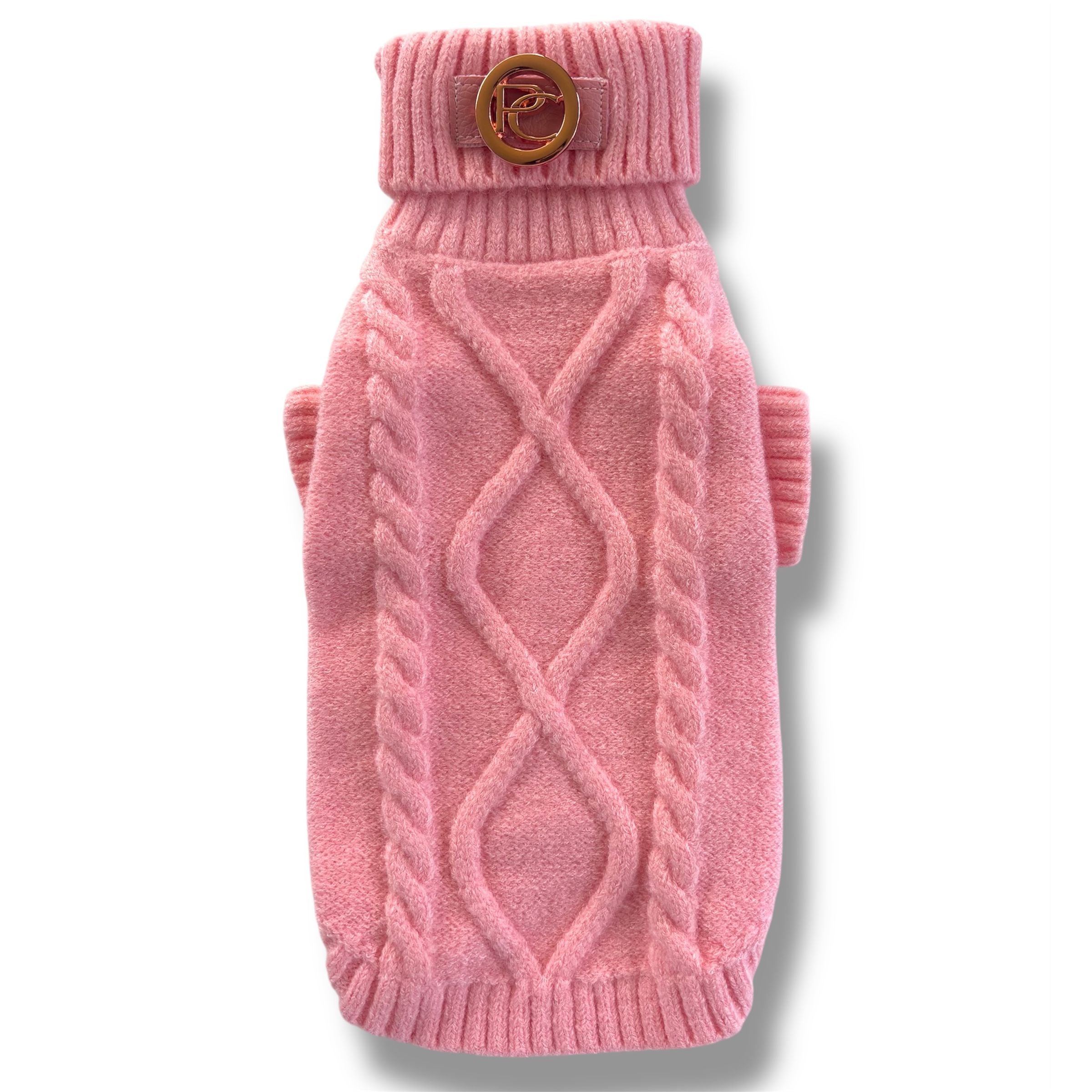 Pink knitted dog sweater with a brown button on a white background