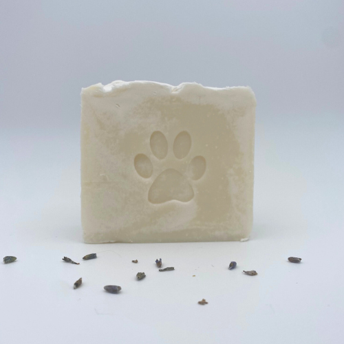 Bar of soap with a paw print design on a white background