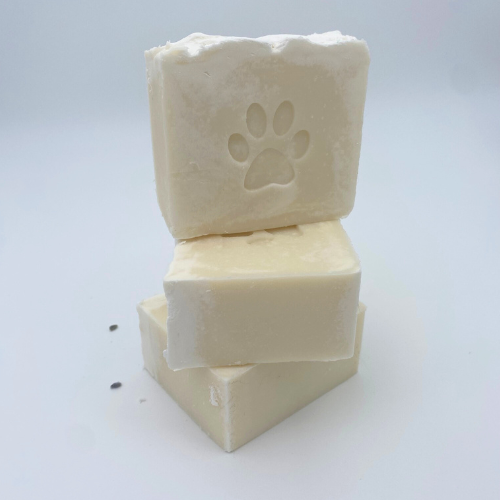 Three blocks of soap with a paw print design on a white background