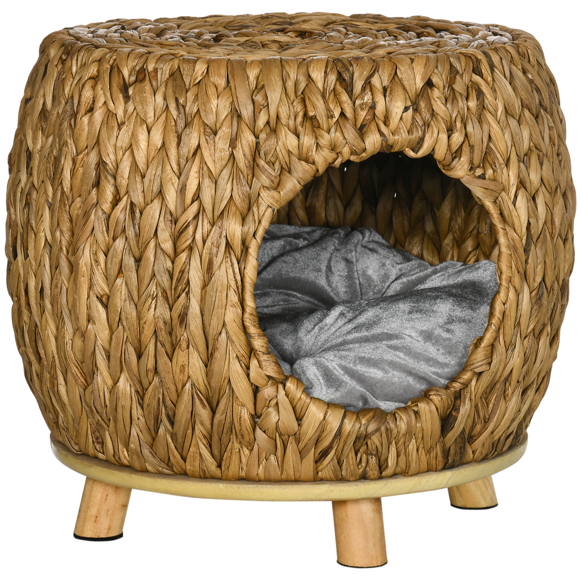Rattan pet bed with a gray cushion inside on a white background