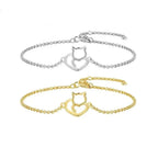 Silver and gold cat-shaped bracelet on a white background