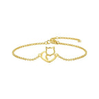 Gold bracelet with a cat-shaped charm on a white background