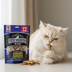 Cat eating a Rocky Mountain Raw sardine treat with the packaging in the foreground.