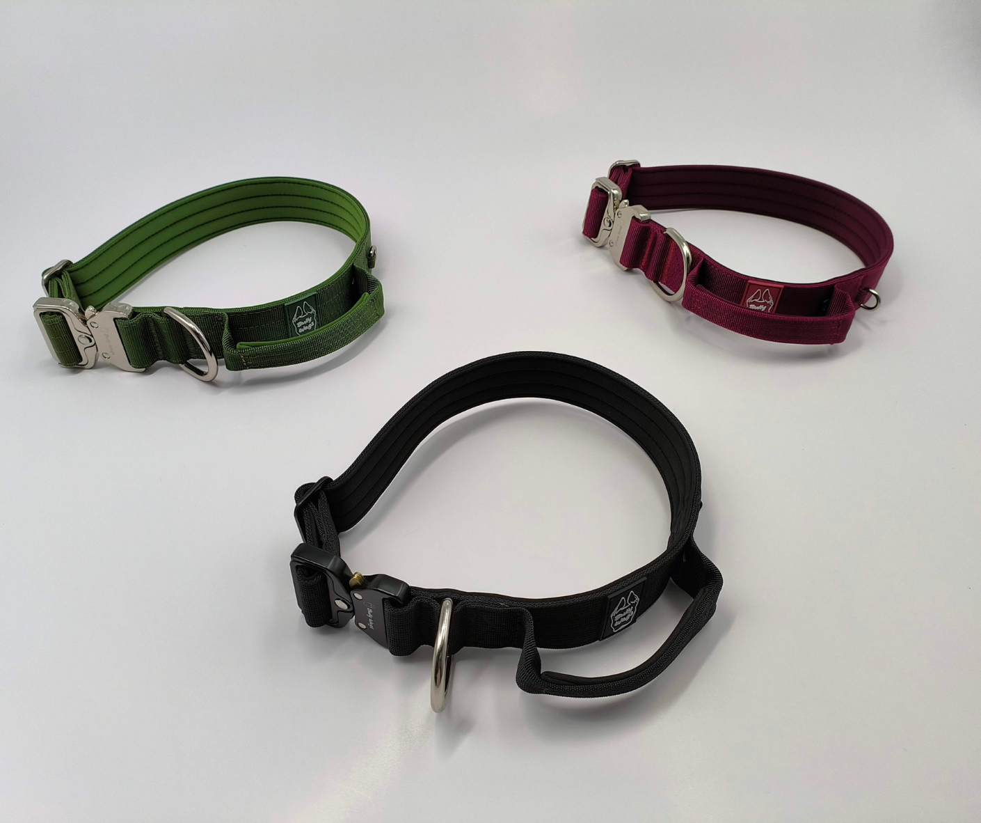 Three dog collars in green, black, and red on a white background
