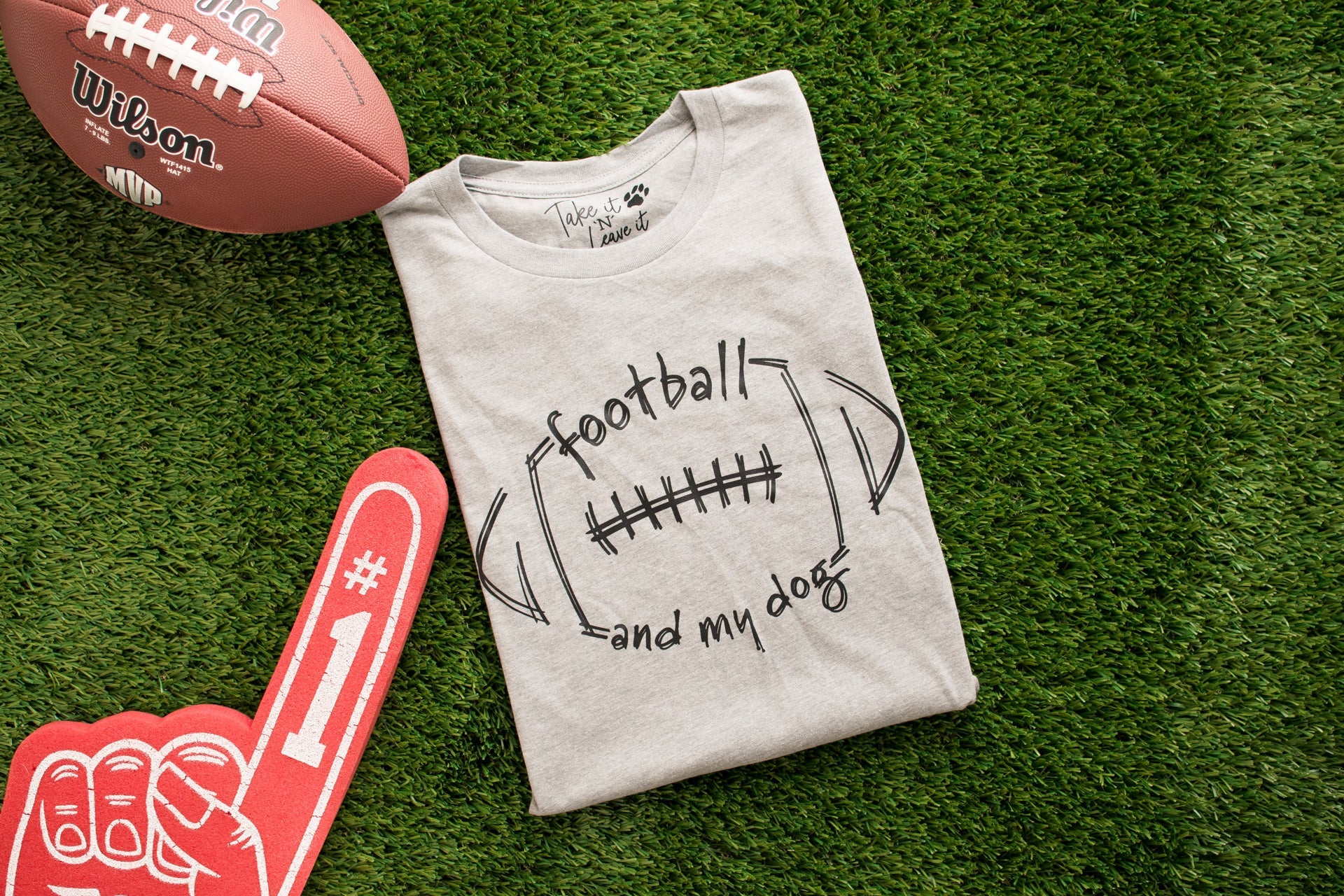 Gray t-shirt with 'football and my dog' design on grass with Wilson football and foam finger.