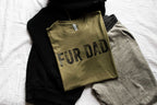 Folded sweatshirt with 'FUR DAD' text on a white surface
