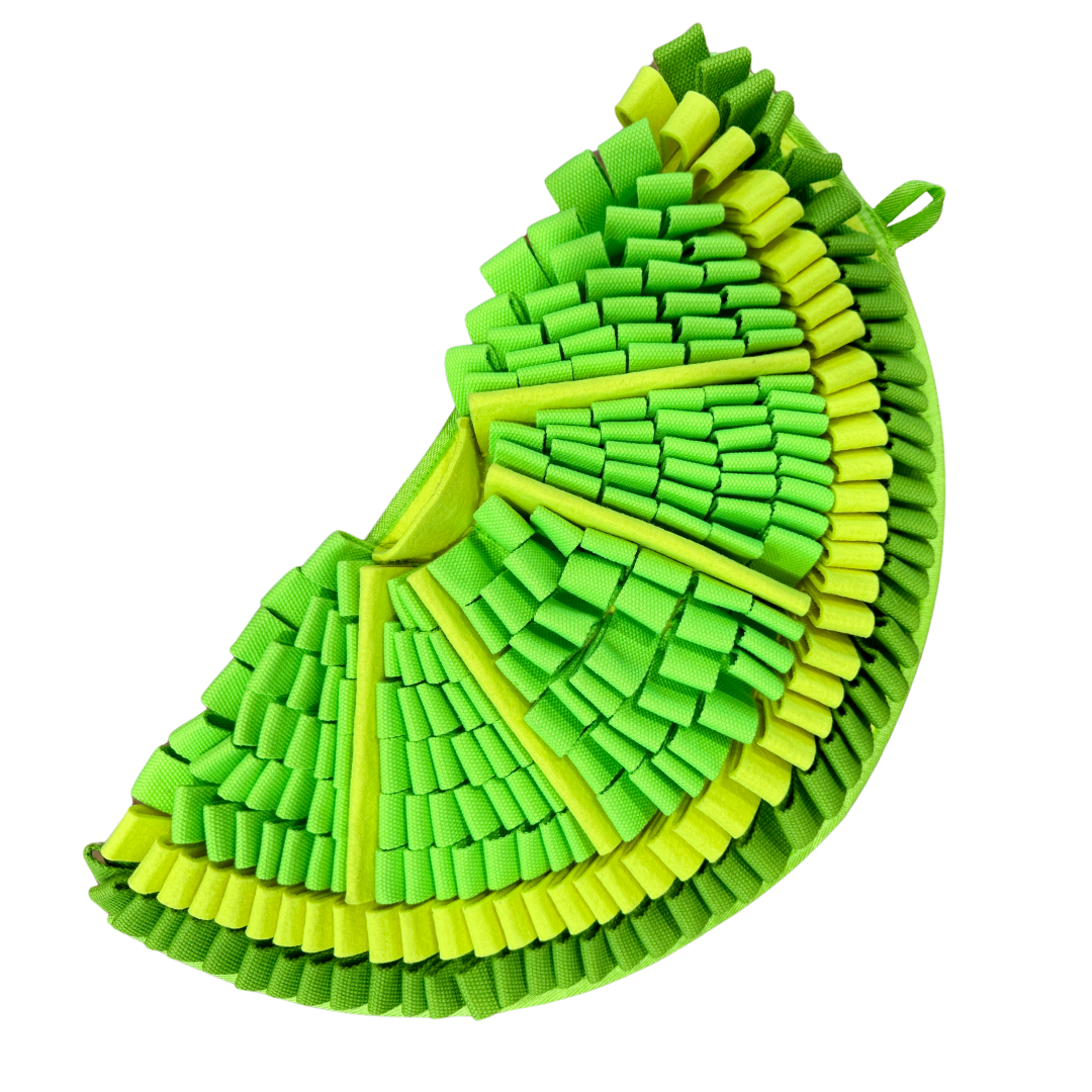 Green and yellow lime-shaped snuffle mat on a white background