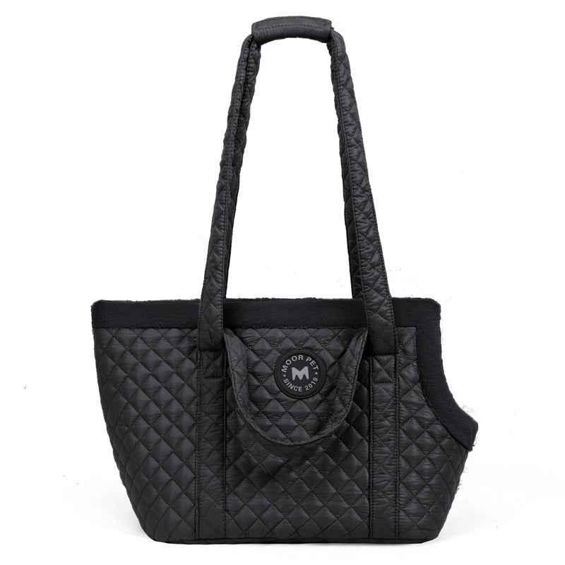 Black quilted pet carrier with a visible brand logo on a white background