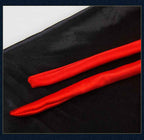 Two red fabric strips on a black background