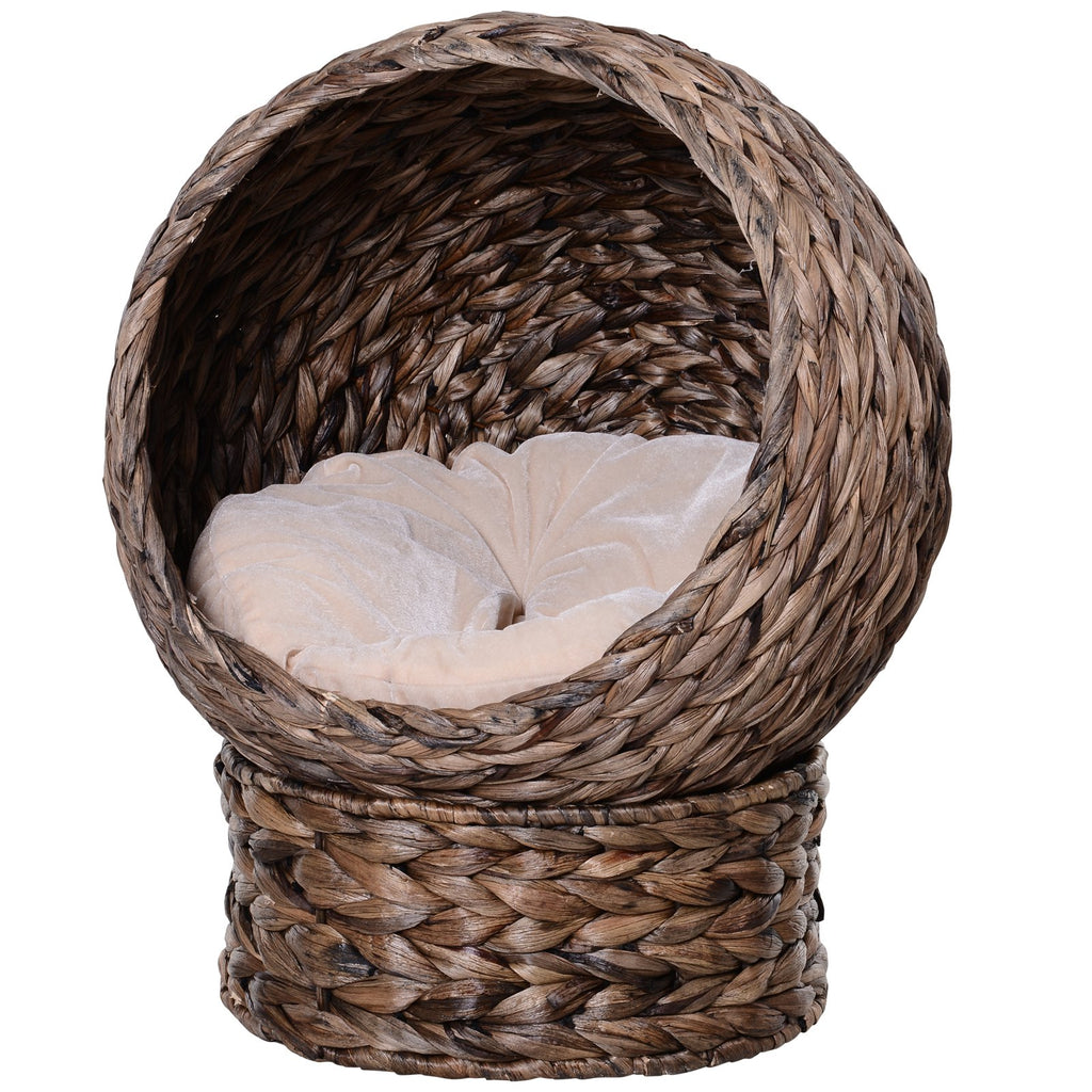 Woven pet bed with a soft white cushion on a white background