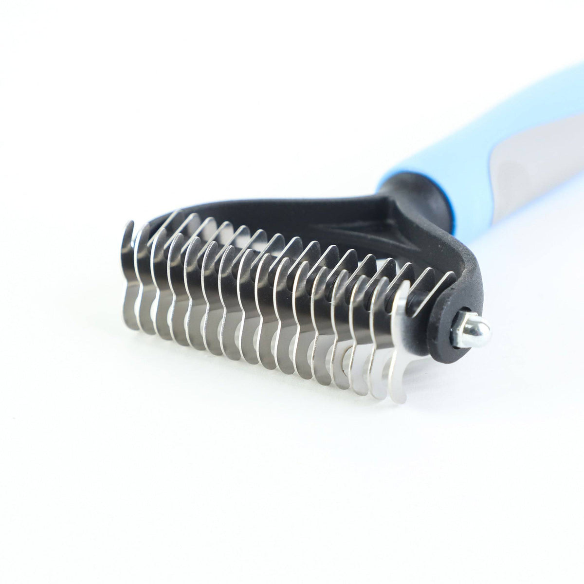 Grooming tool with metal bristles on a white background