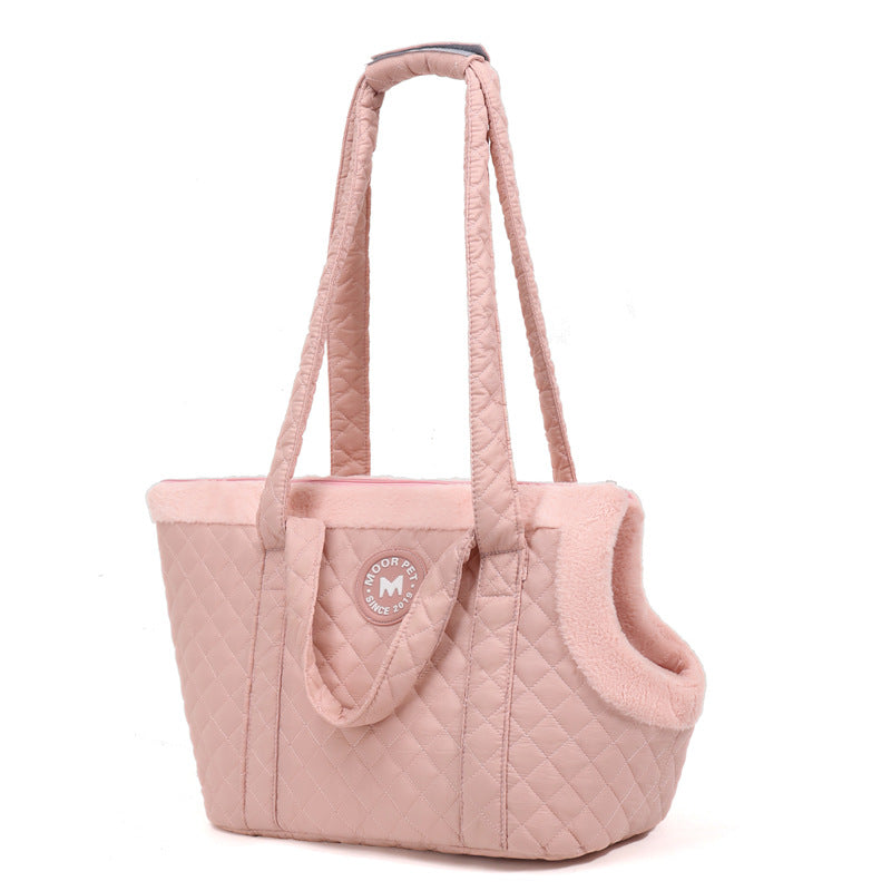 Pink quilted pet carrier with a visible brand logo on a white background