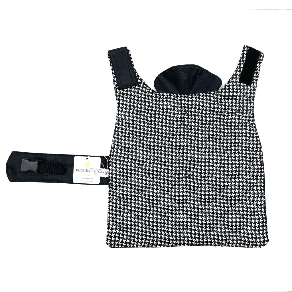 Black and white houndstooth patterned dog coat with a matching harness on a white background