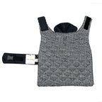 Black and white houndstooth patterned dog coat with a matching harness on a white background