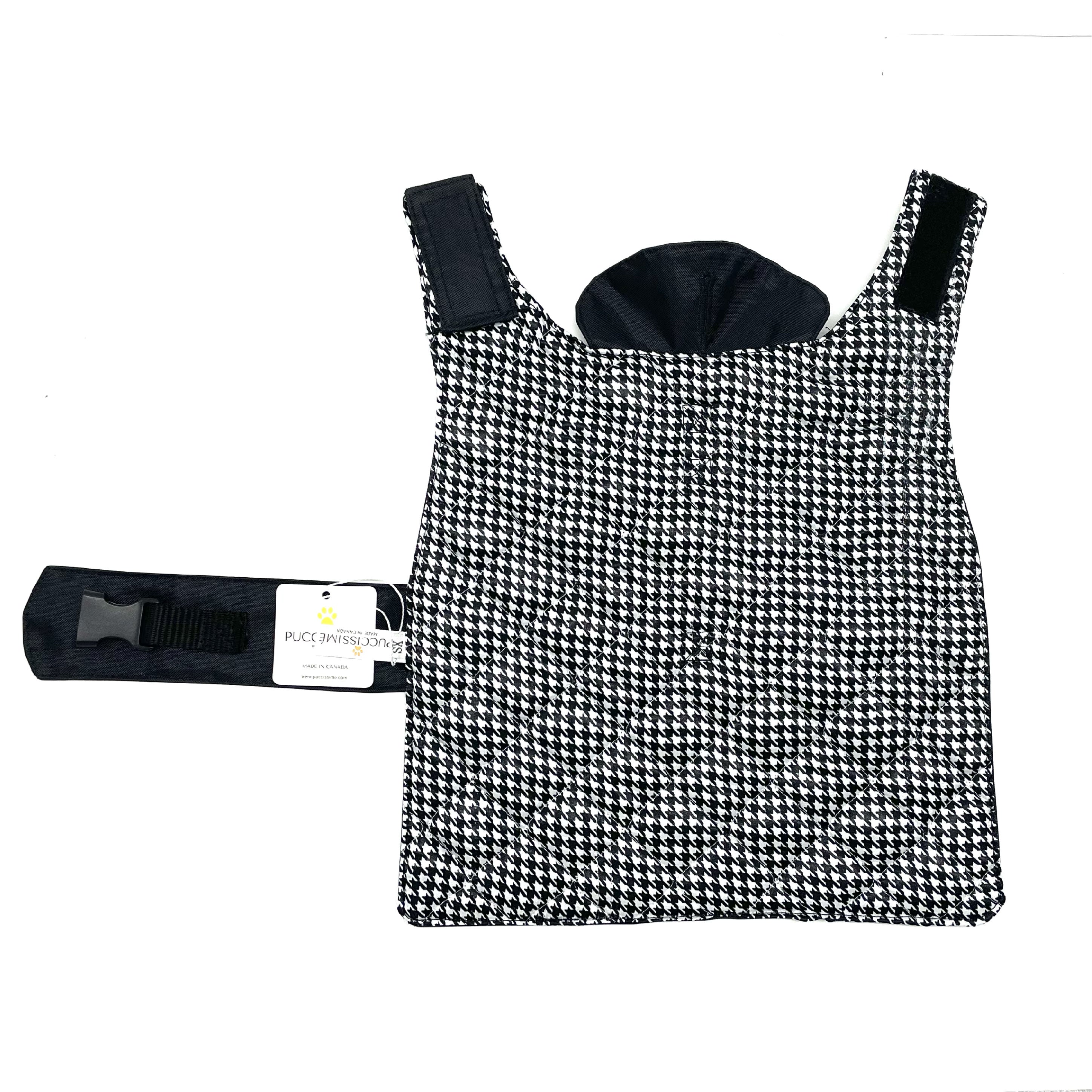 Black and white houndstooth patterned dog coat with a matching harness on a white background
