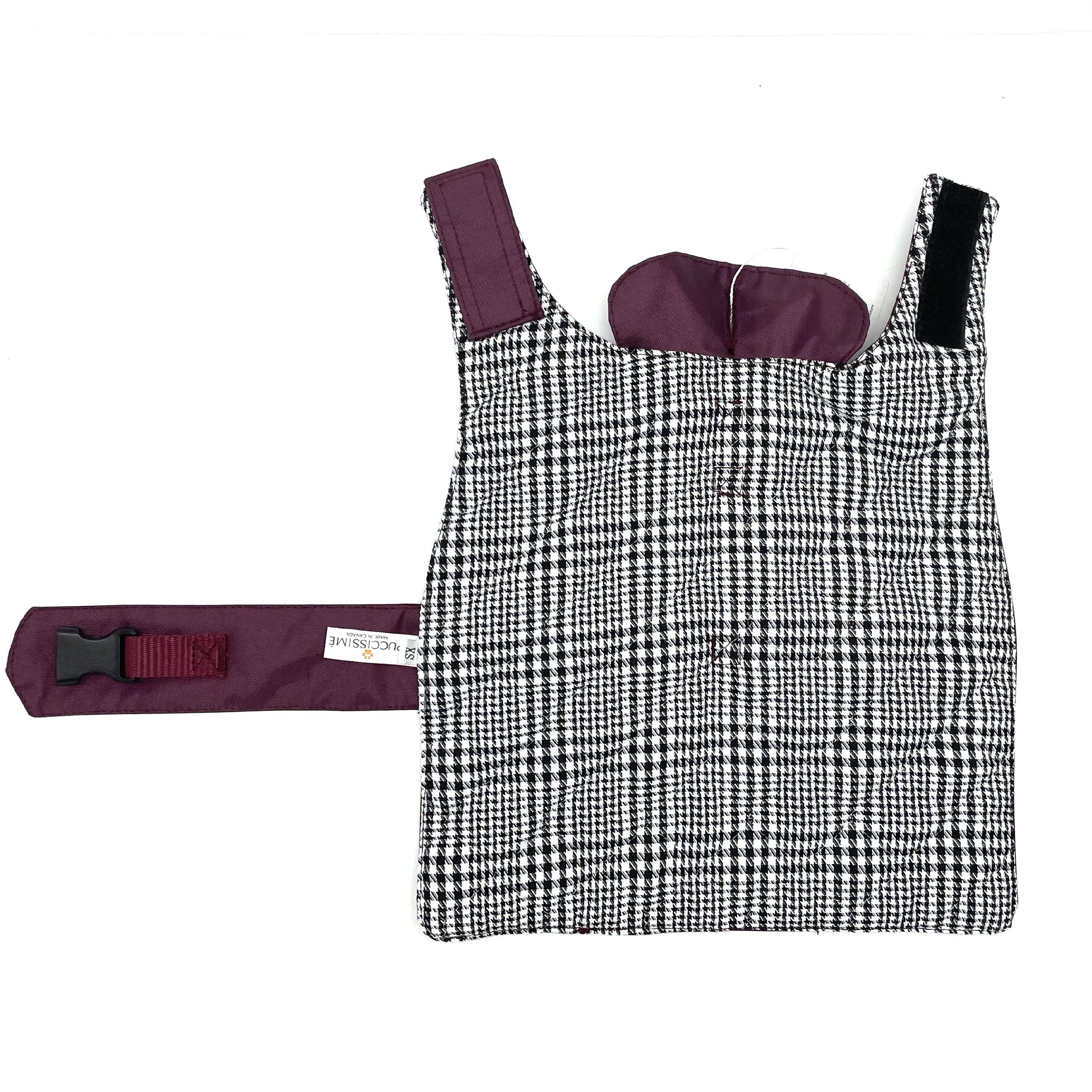 Black and white checkered dog rain coat on a white background