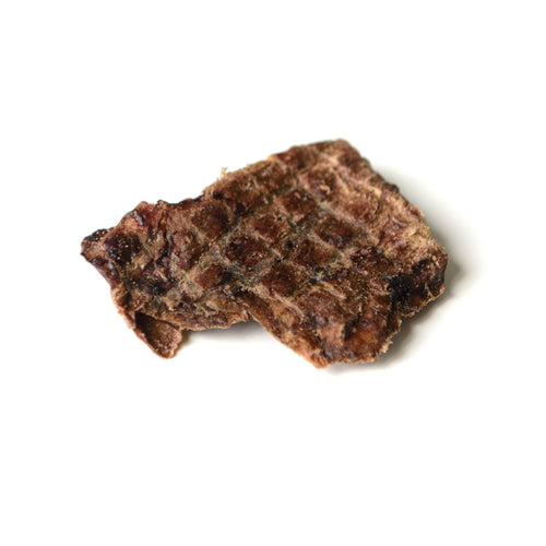 Brown dog treat on a white background