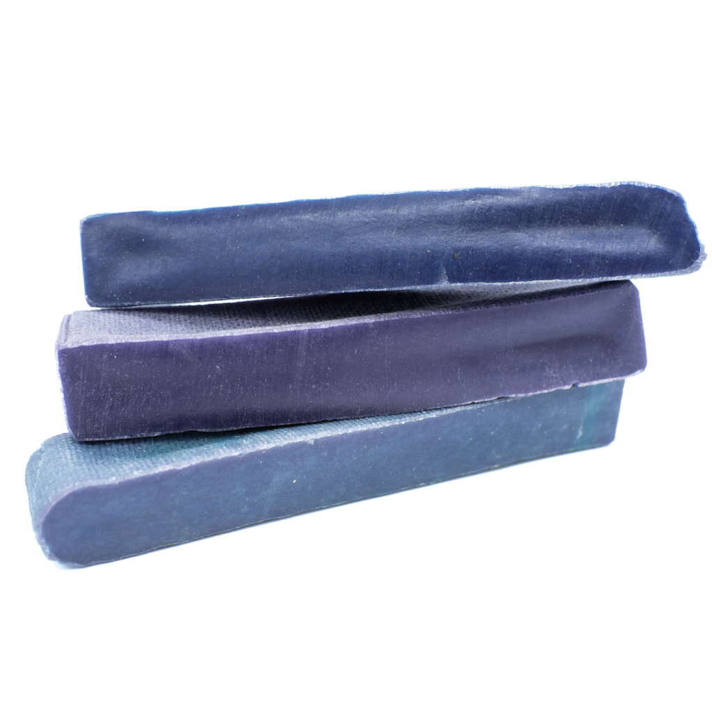 Three blue yak chew stacked on a white background