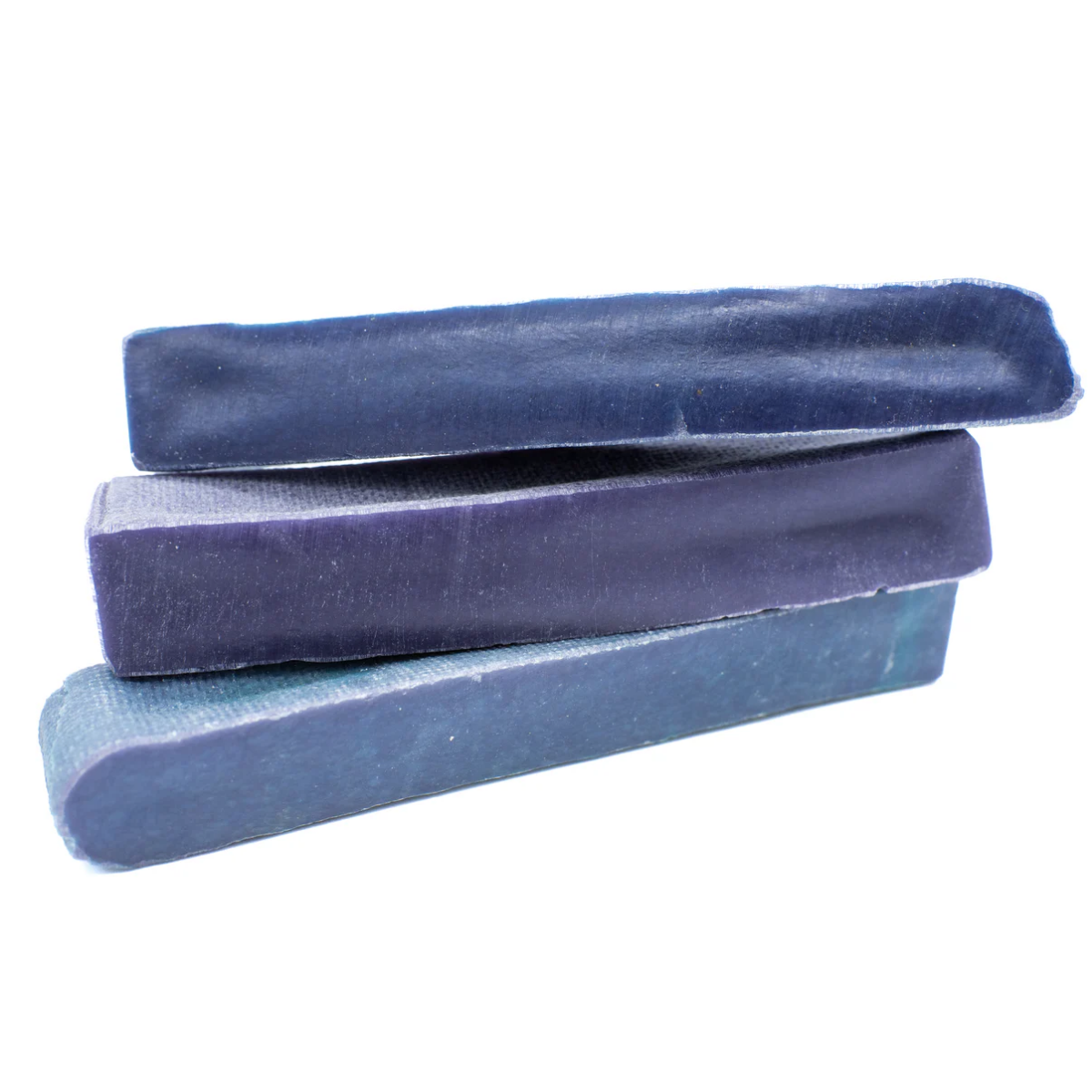 Three blue yak chew stacked on a white background
