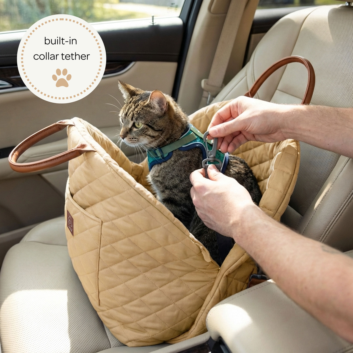 Cat in a beige car seat with a person adjusting a collar tether, inside a vehicle.