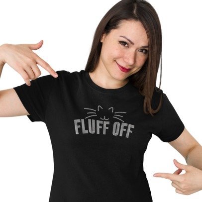 Woman wearing a black t-shirt with 'FLUFF OFF' text design, pointing at the shirt.