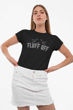 Woman wearing a black t-shirt with 'FLUFF OFF' text and a white skirt on a white background