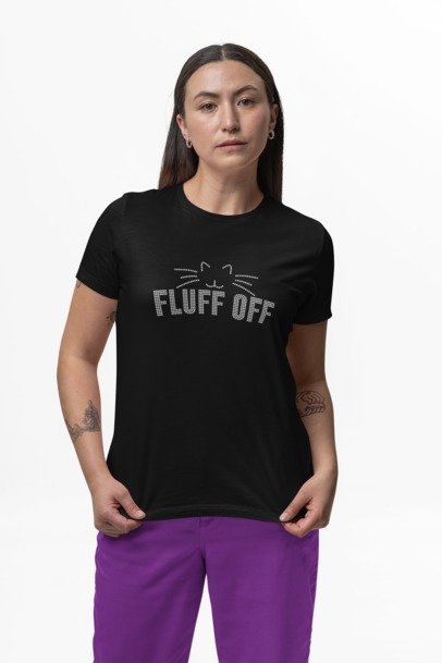 Person wearing a black t-shirt with 'FLUFF OFF' text and purple pants on a white background