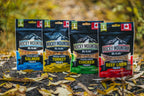 Four packages of Rocky Mountain Raw freeze-dried pet treats on a natural background