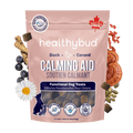 Package of healthybud Calming Aid dog treats with natural ingredients on a green background