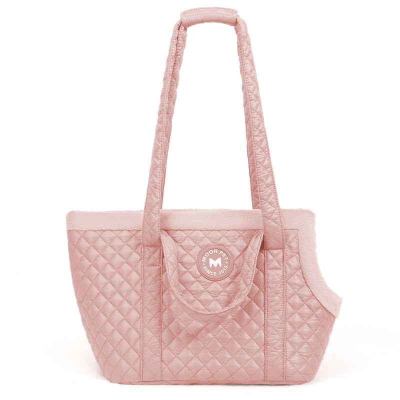 Pink quilted pet carrier with a visible brand logo on a white background