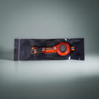 Orange and black dog collar on a reflective gray background