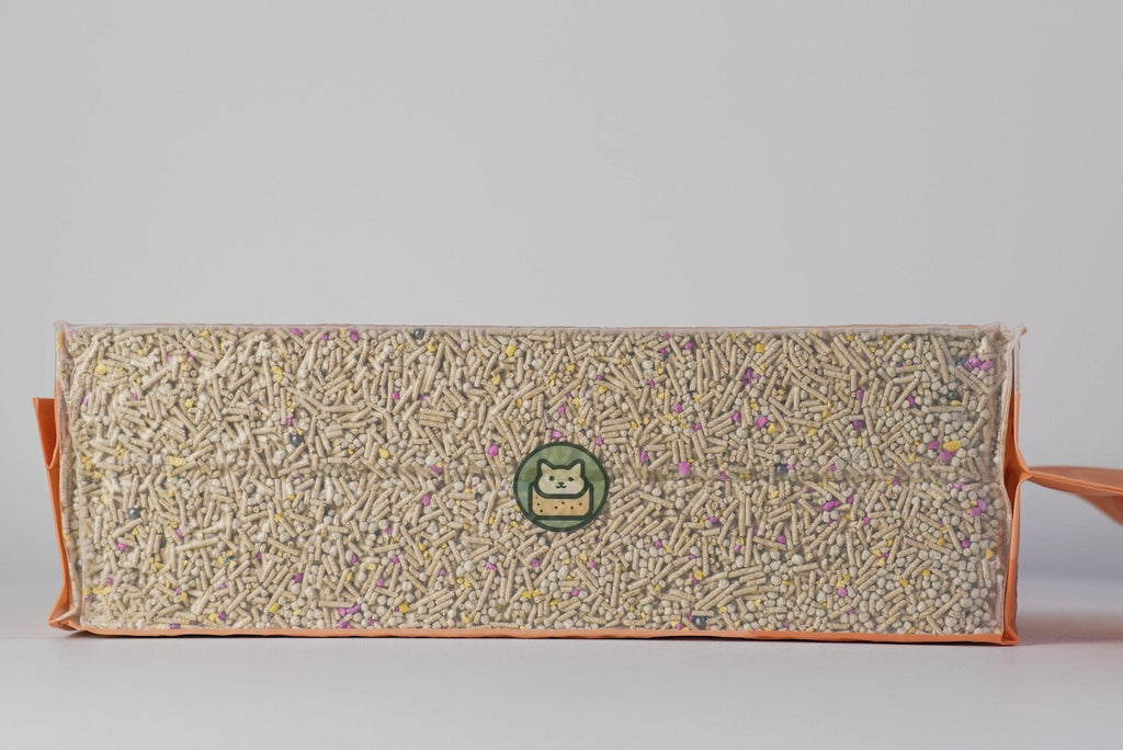 Rectangular block of cat litter and green logo on a light gray background